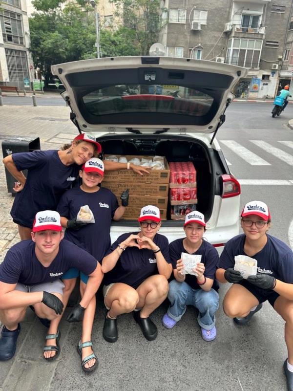 Oppenheim family with a food delivery in the back of a car